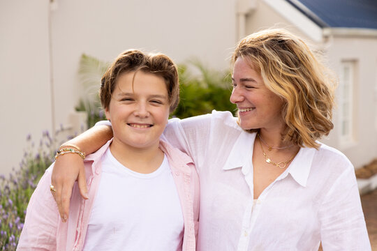 portrait of siblings outside their home