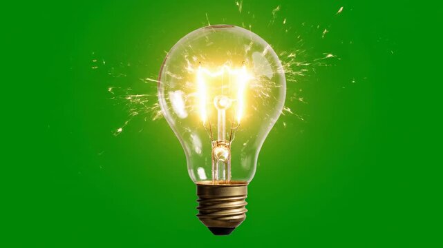 Incandescent light bulb ignites with sparks on green screen background cinematic motion