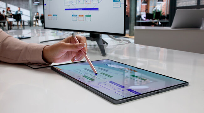 Young Woman Using Tablet To Drag And Drop Elements