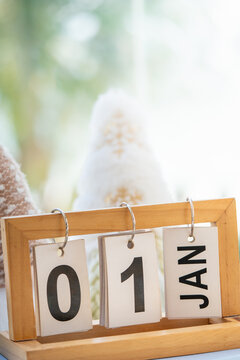 New Year's Day concept with a wood desktop calendar displaying January 1.
