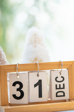 New Year's Eve concept with wooden desktop calendar displaying December 31.