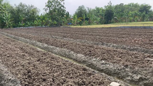 Agricultural land with irrigation ditch ready for planting