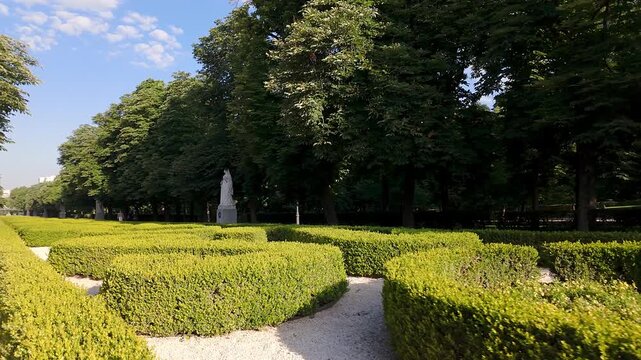Statue walk with trimmed hedges and large trees, Retiro, Madrid.