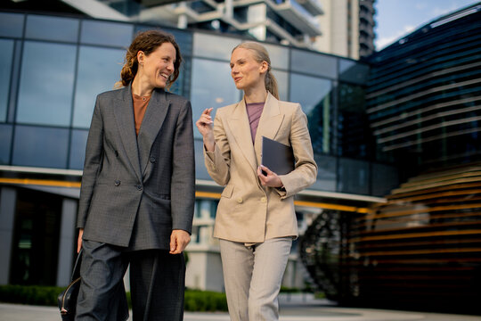 Business meeting between two women outside a modern building in the city