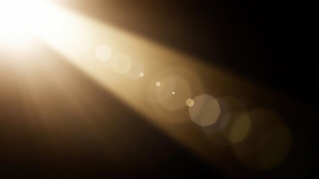 Bright cinematic light beam with lens flare and bokeh circles on black background