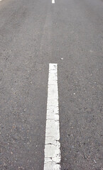 Fototapeta premium Dashed line markings on the road as a lane divider between two vehicle flows