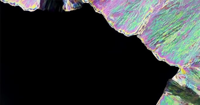 Extreme Macro video of abstract microscopic crystal formation growing under polarized light