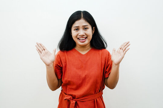 Portrait of happy Asian woman raising hands with open palms smiling at camera welcoming or presenting isolated on white background