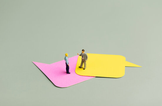Miniature businessmen on ]speech bubbles,business discussion, communication and partnership meeting