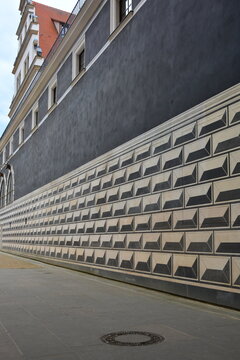A long wall of the palace in Dresden with a large-scale geometric sgraffito painting that creates a 3D effect of volumetric blocks