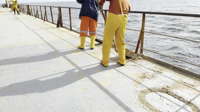 When hard work goes wrong in a funny way. Bulk carrier crew shovels spilled wheat overboard. Mid-task, sailor&rsquo;s pants split at seat. Candid, hilarious moment showing the human side of maritime jobs.