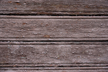 Fototapeta premium Close-Up View of Weathered Wooden Planks Showing Textured Surface with Flaking Paint and Natural Imperfections