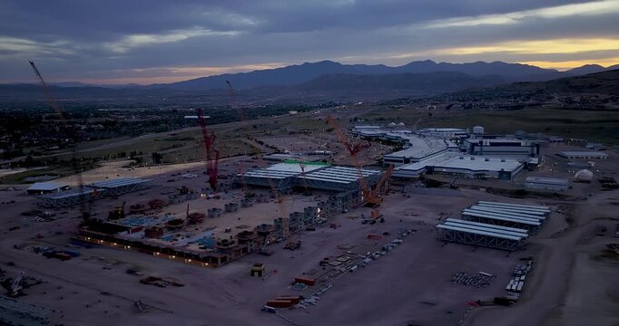 This large construction site next to Texas Instruments (TI) in Lehi, Utah, will become a semiconductor wafer fabrication plant, known as LFAB2 - wide angle aerial parallax at sunset.