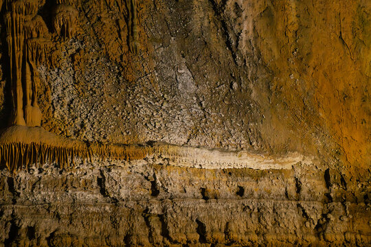 Interior view of Ali Sadr Cave in Hamedan Province, Iran, featuring a naturally formed limestone wall resembling a crocodile. 
