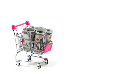 Dollars in a shopping cart on a white background, business and finance © AI-Valentin