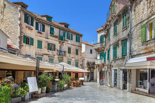 Street in historical center of Split Croatia view. Ancient stone buildings under sunny sky
