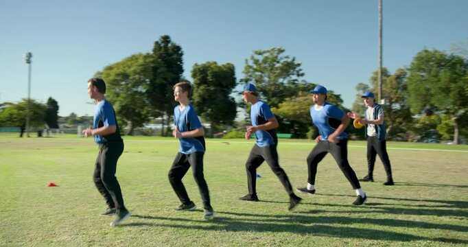 Male coach using disc and whistle guiding male teammates squatting and jumping around cones