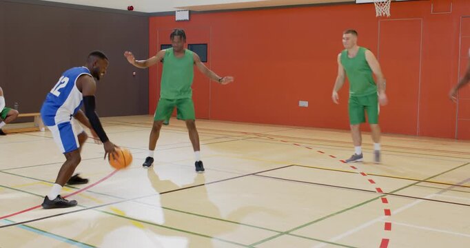 Following pick, african american man in blue jersey dribbling, shooting jumper to score on court