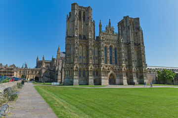 Fototapeta premium A grand Gothic cathedral with two tall towers stands against a bright blue sky - Wells Cathedral - Wells - Somerset - UK