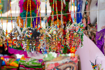 Obraz premium Colorful Huichol Beaded Hummingbird Ornaments Displayed at a Mexican Artisan Market
