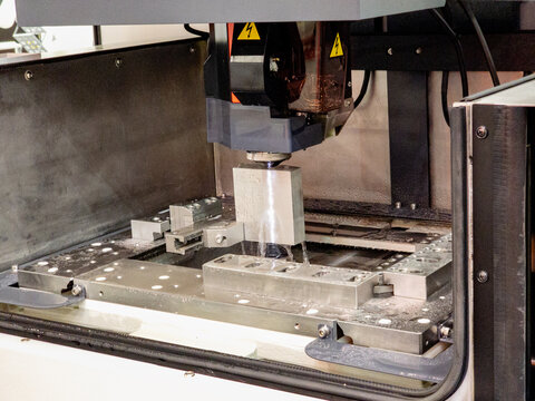 High-Precision Wire EDM Machine Processing Metal Workpiece with Coolant in CNC Manufacturing Factory