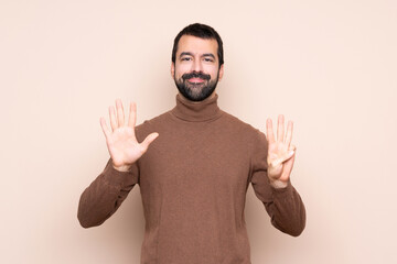 Fototapeta premium Man over isolated background counting eight with fingers