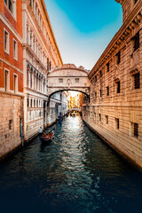 Obraz premium Stunning Venice Bridge of Sighs narrow canal. Historic Italian architecture warm golden light. Vertical romantic Venezia scene gondola waterway. Inspirational European travel landmark, summer vacation