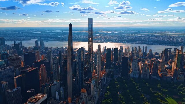 Spectacular aerial panorama of Midtown Manhattan at golden hour, showcasing the ultra-slender skyscrapers of Billionaires' Row rising above the city skyline