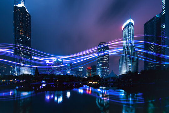 Futuristic smart city with digital data light trails at night.