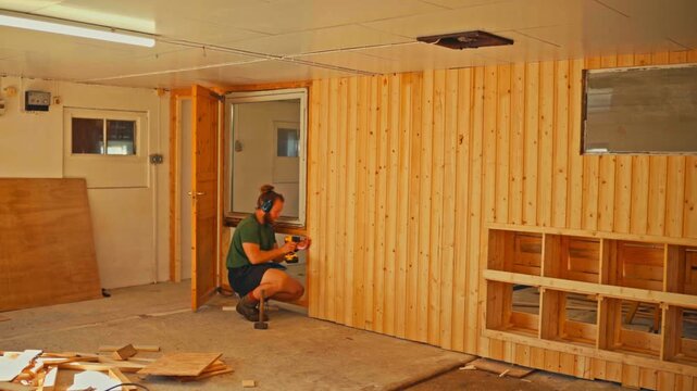 Man Constructing A DIY Project Indoors, Pine Tongue And Groove Wood Paneling - Timelapse