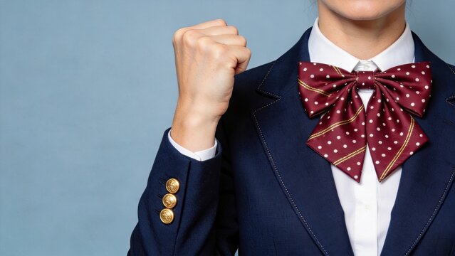 School girl in uniform making fist pump gesture of success and victory, academic achievement and celebration concept, student motivation and confidence building for educational
