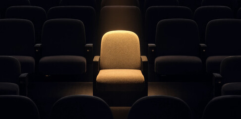 Fototapeta premium Textured cinema seat highlighted by a warm spotlight in an empty theater auditorium with spotlight auditorium lighting entertainment solitude performance interior abstract atmosphere