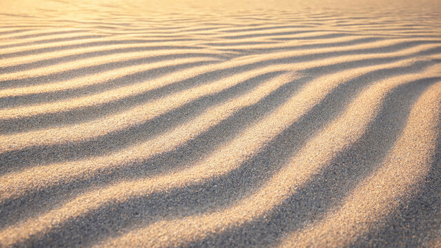 Closeup of sand ripples on a beach at sunset