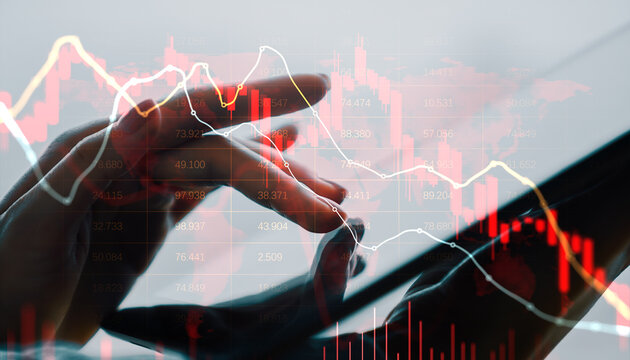 Business person using digital device with falling red financial chart showing global market crash and economic decline concept.