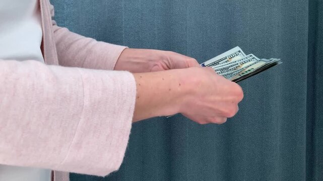 The woman counts the money. Planning of future investments and assessment of financial possibilities. The topic of investments, savings and competent personal capital management