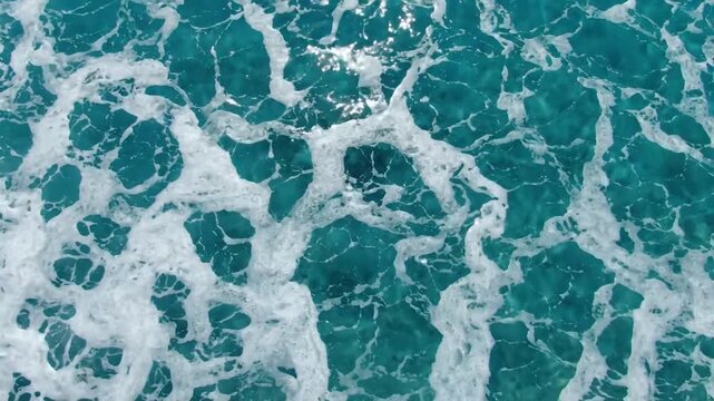 Ocean waves with sea foam and deep blue green water, a natural beautiful background texture with movement and energy