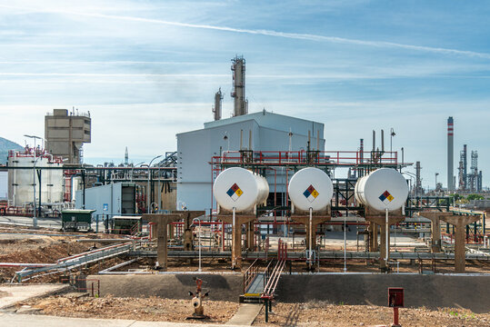 Storage tanks at refinery marked with NFPA 704 hazard diamond to help emergency responders identify chemical risks