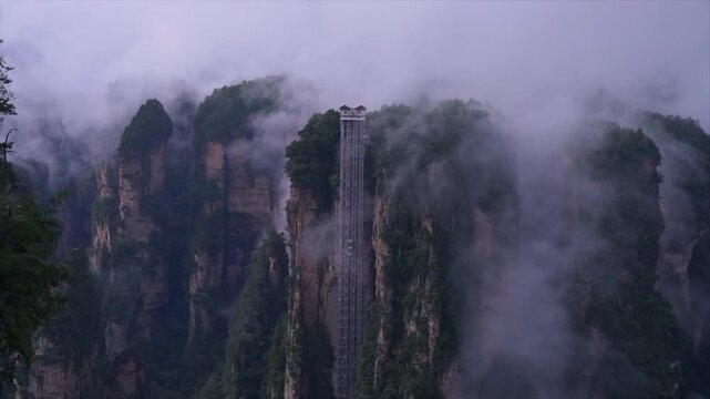 Bailong Elevator Rising Through Misty Zhangjiajie Sandstone Peaks in Zhangjiajie National Forest Park, China