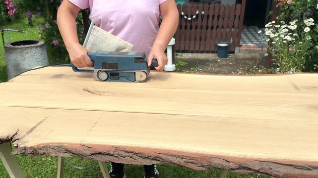 Craftsman Sanding Oak Plank for Furniture