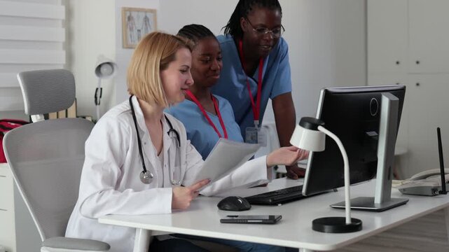 Doctors and nurses collaborating in a hospital office in the afternoon