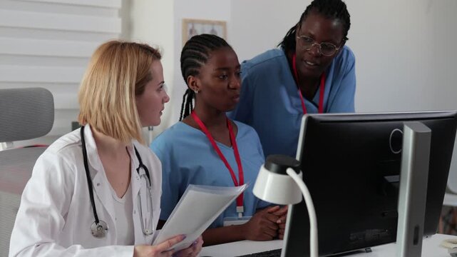 Staff members discussing patient care in a clinic setting during afternoon hours