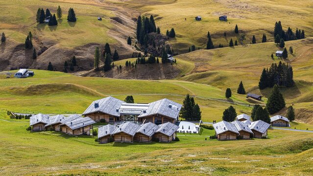 Wellness Resort Adler Mountain Lodge and autumnal alpine meadows, Alpe di Siusi, Val Gardena, Dolomites, South Tyrol, Italy