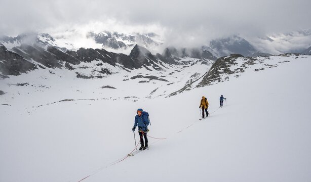 Ski tourers walking on the rope on the glacier in winter in the mountains, Alpeiner Ferner, Oberbergtal, Neustift im Stubai Valley, Tyrol, Austria