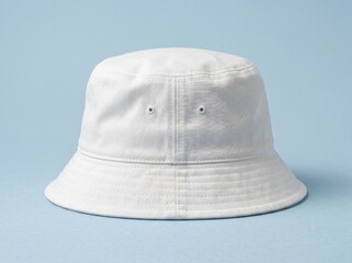 Fototapeta premium A white bucket hat mockup is placed on a plain blue background.