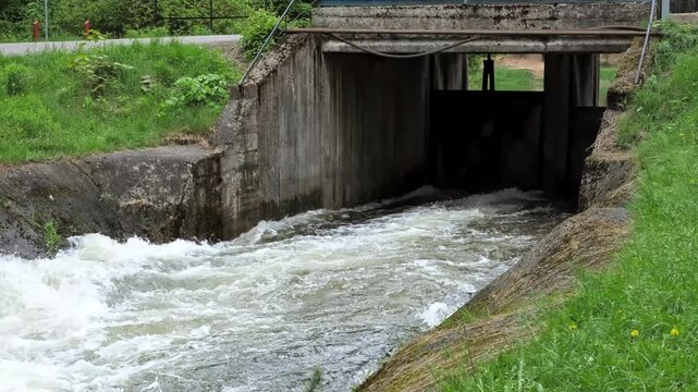 Opened lock of river. Whitewater Slalom course. Fast water flows rapidly among large grey rocks in a mountain stream. mountain river, rushing water, natural landscape. Artificial channel. 4K footage.