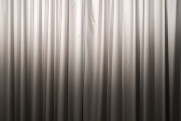 Obraz premium Close-up view of closed beige curtains with soft fabric folds, creating a simple neutral interior background or texture.