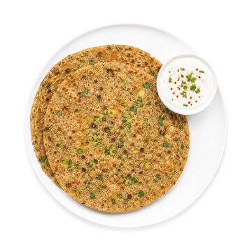 Traditional Gujarati vegetable handvo cake served with yogurt dip on white plate. Ai generative
