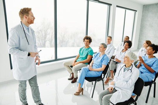Portrait of a young doctor teaching on a seminar in a board room or during an educational class at convention center