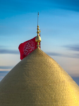 Karbala, Iraq - December 28, 2025: Golden dome and illuminated minarets of the Imam Hussain Shrine glowing at dusk in Karbala, Iraq	