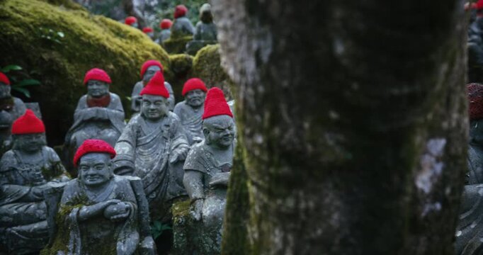 Jizo Stone Statues Red Hats In Moss Garden, Miyajima Japan - Steady Cam Shot